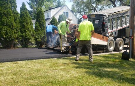 Paving contractors sealcoating a driveway