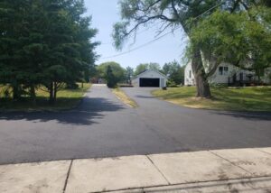 Freshly Paved Long driveway surrounded by trees