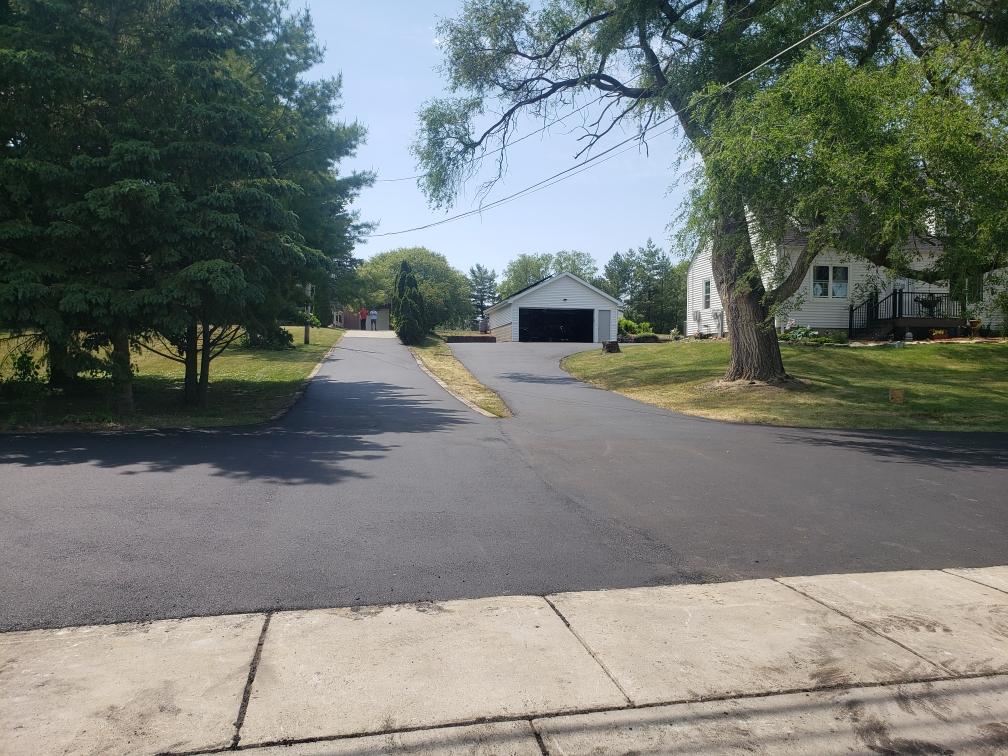 Freshly Paved Long driveway surrounded by trees